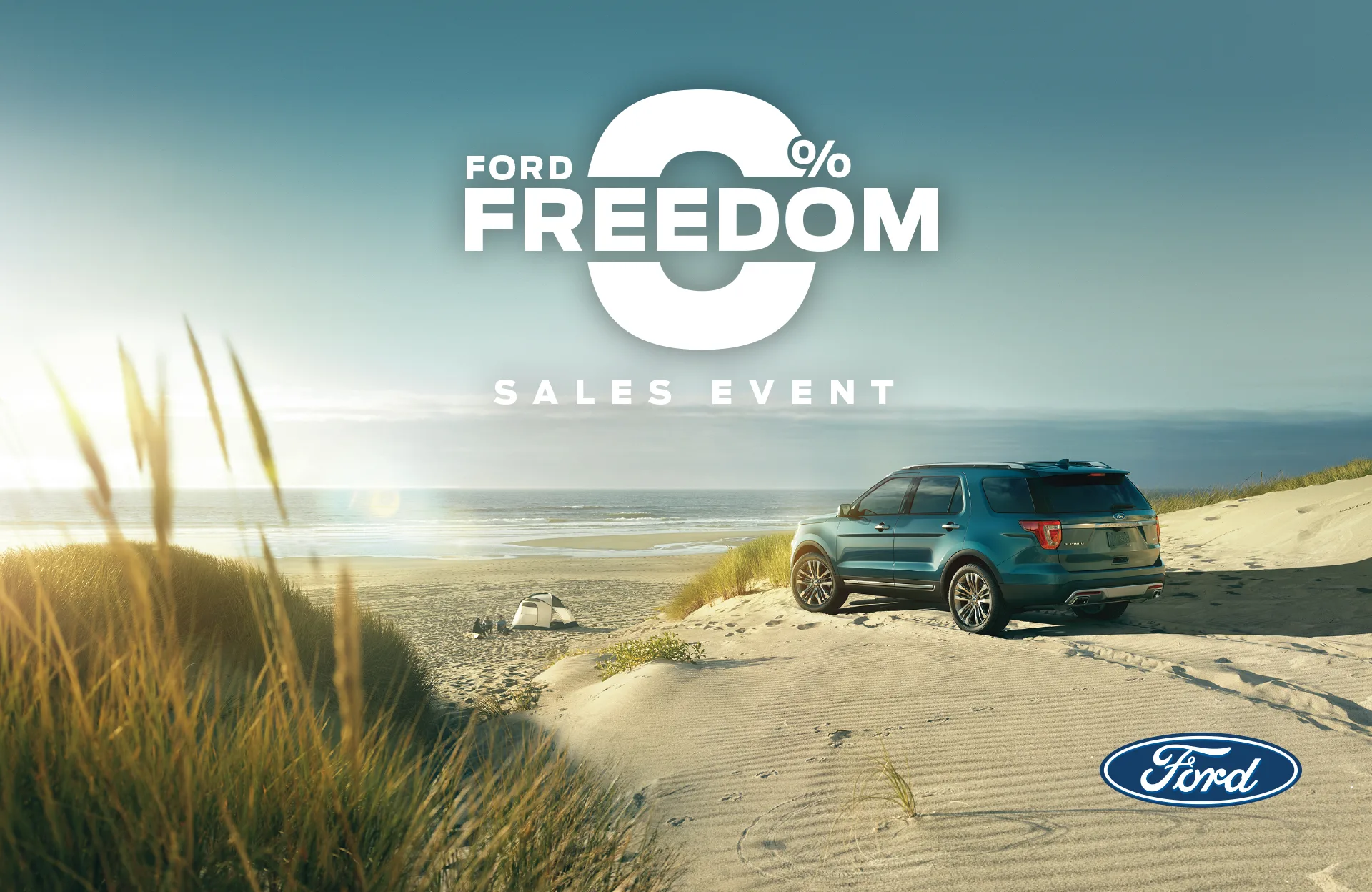 Ford 0% Freedom Sales Event ad: a teal Ford Explorer parked on sunlit beach dunes beside the ocean