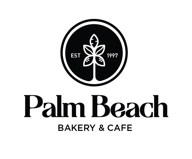 Palm Beach Bakery & Cafe logo: a white wheat sprig inside a solid black circle marked "EST 1997", above a high-contrast serif wordmark