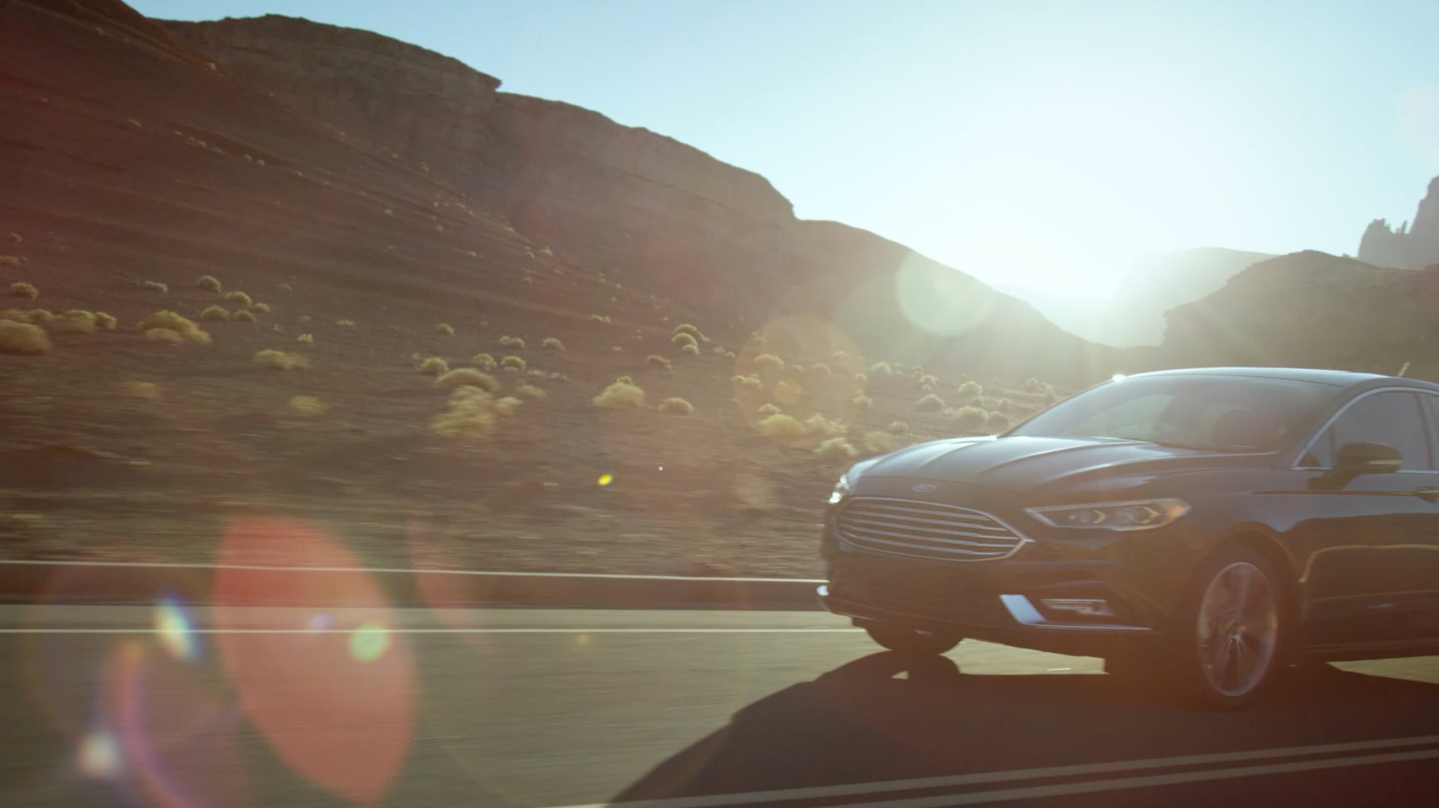Ford Fusion driving a desert road at sunset, Designed for the Desert