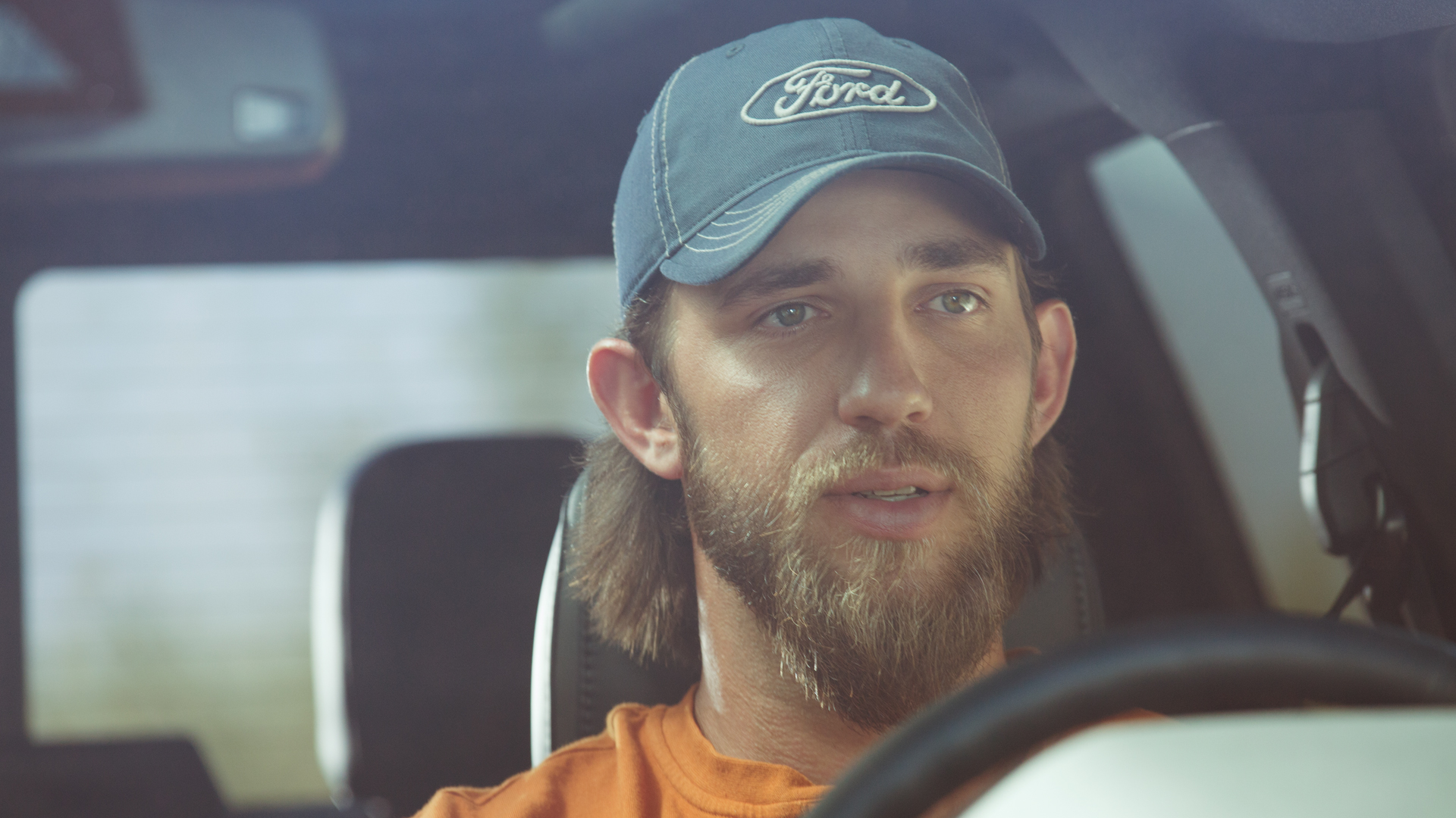 Madison Bumgarner in a Ford cap behind the wheel of a Super Duty
