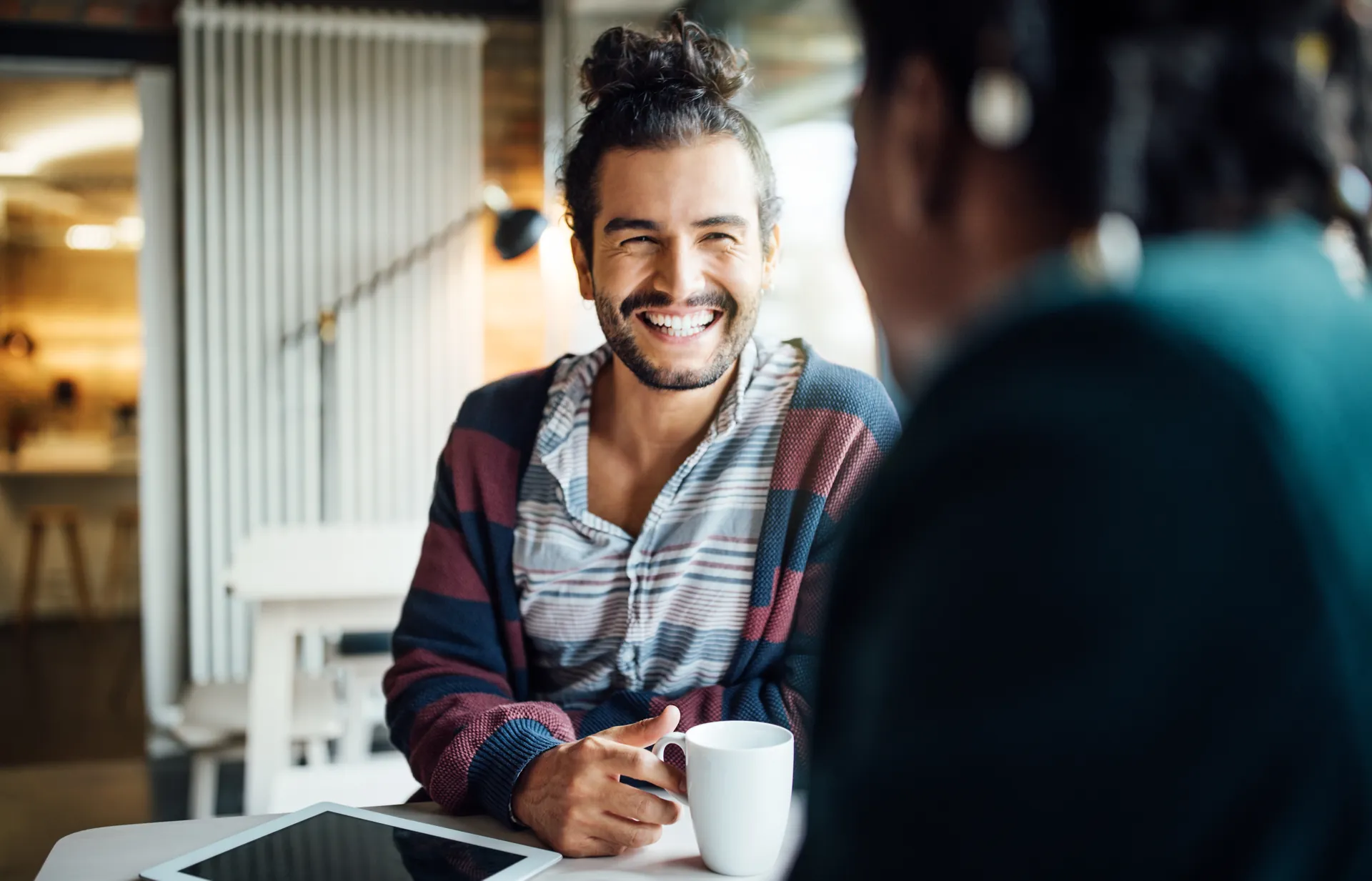 Smiling man in a business meeting at a cafe