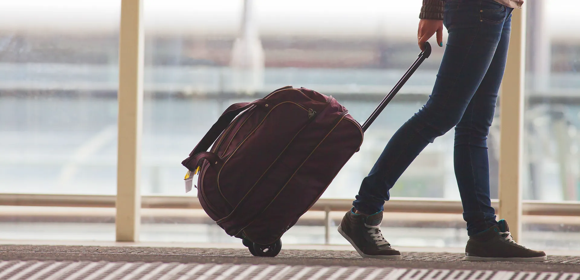Traveller pulling a suitcase through an airport