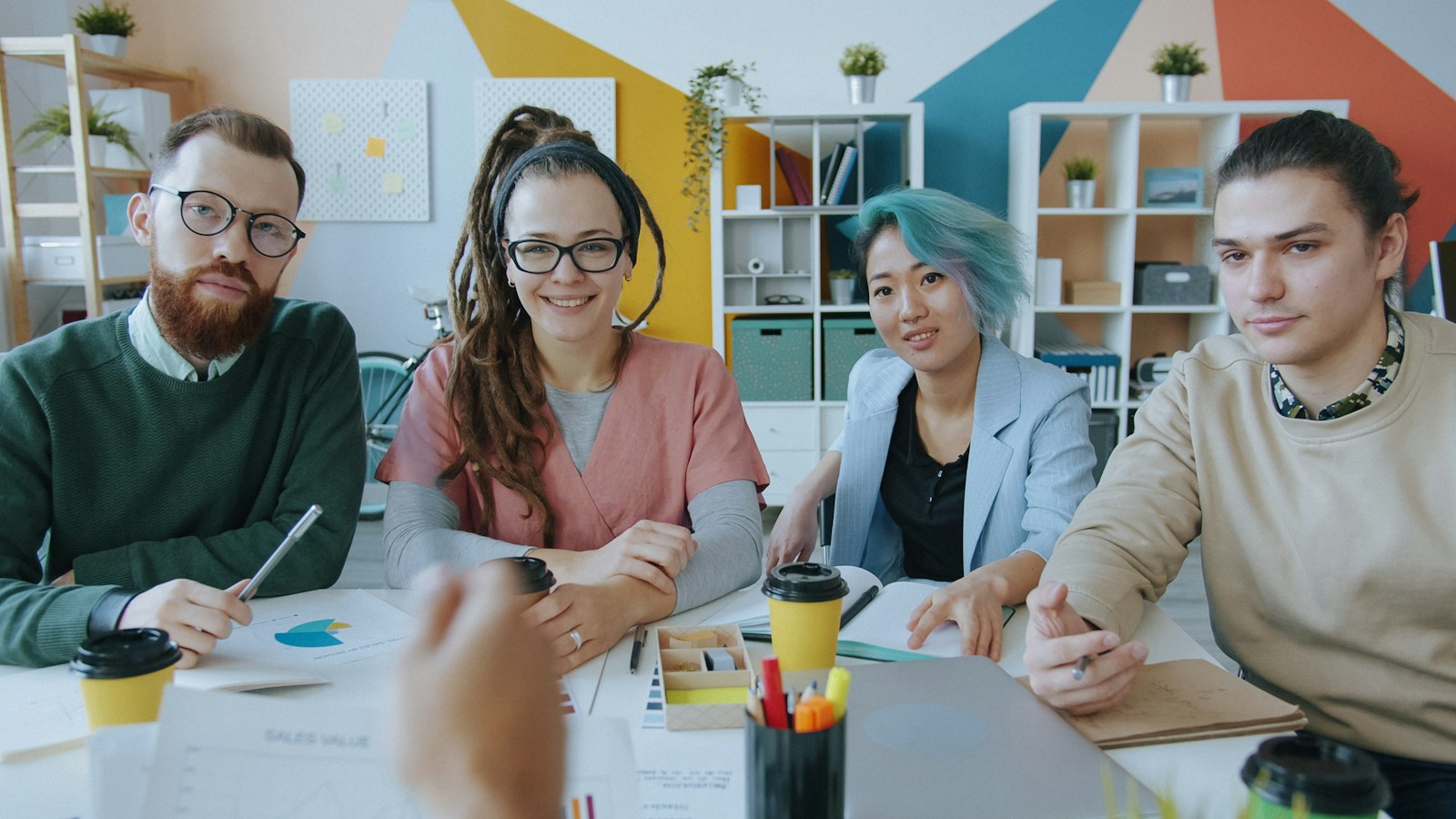 Compliance and marketing team meeting in a colourful office