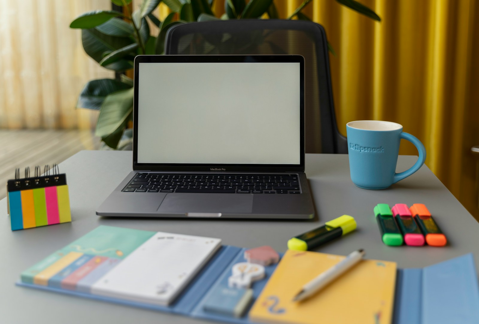 Bright workspace with laptop and colourful sticky notes