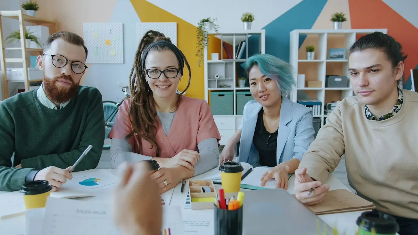 Compliance and marketing team meeting in a colourful office