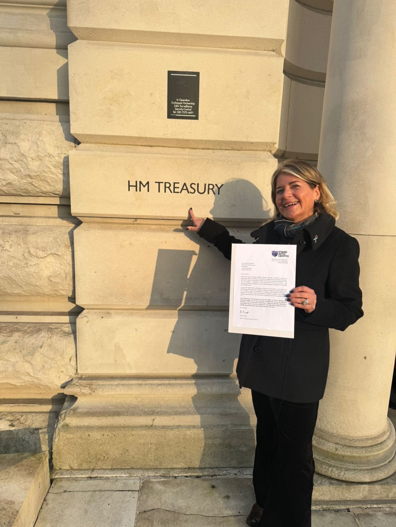 Campaigner holding a letter outside HM Treasury in London