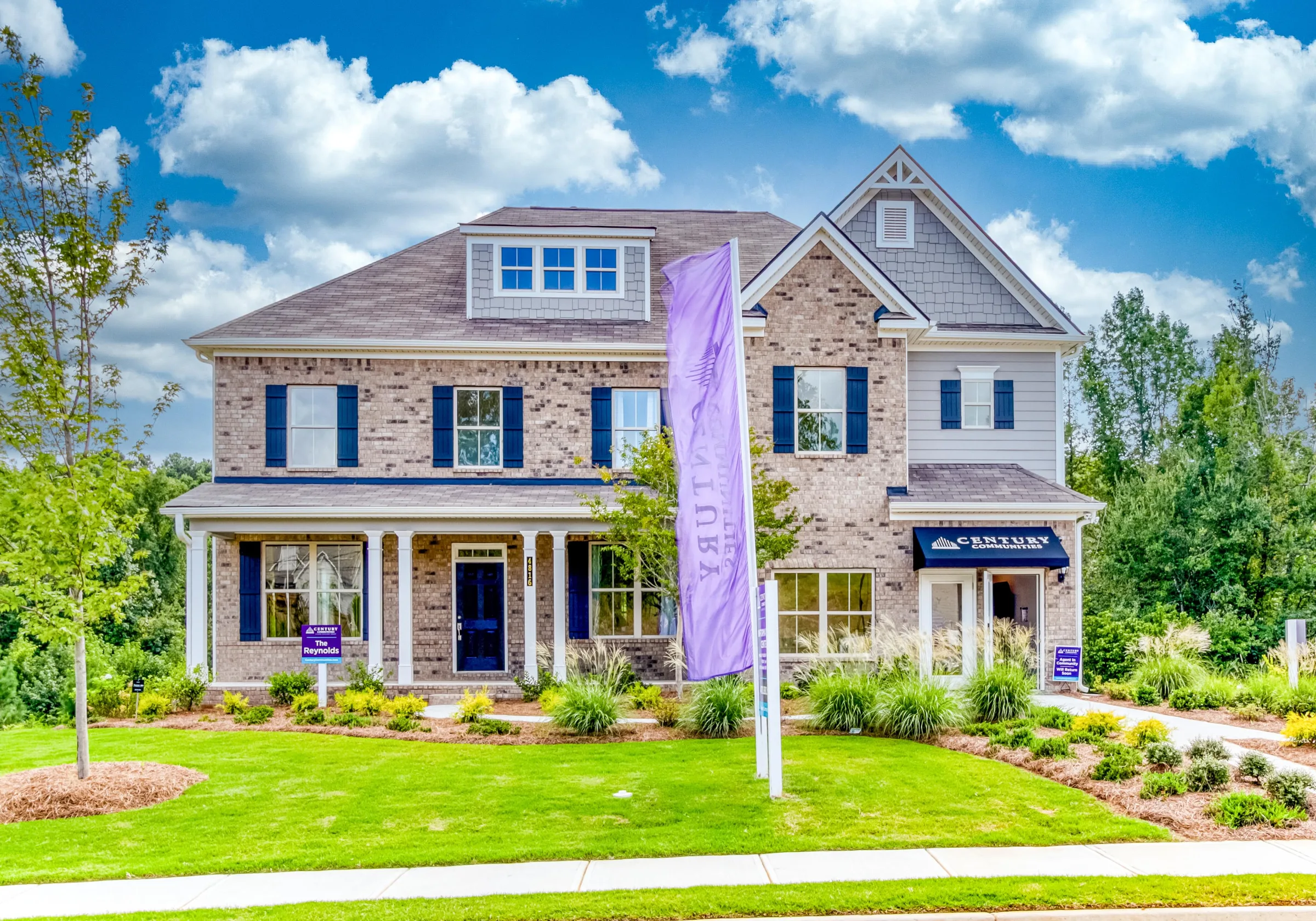New-construction two-story home with stone and siding exterior