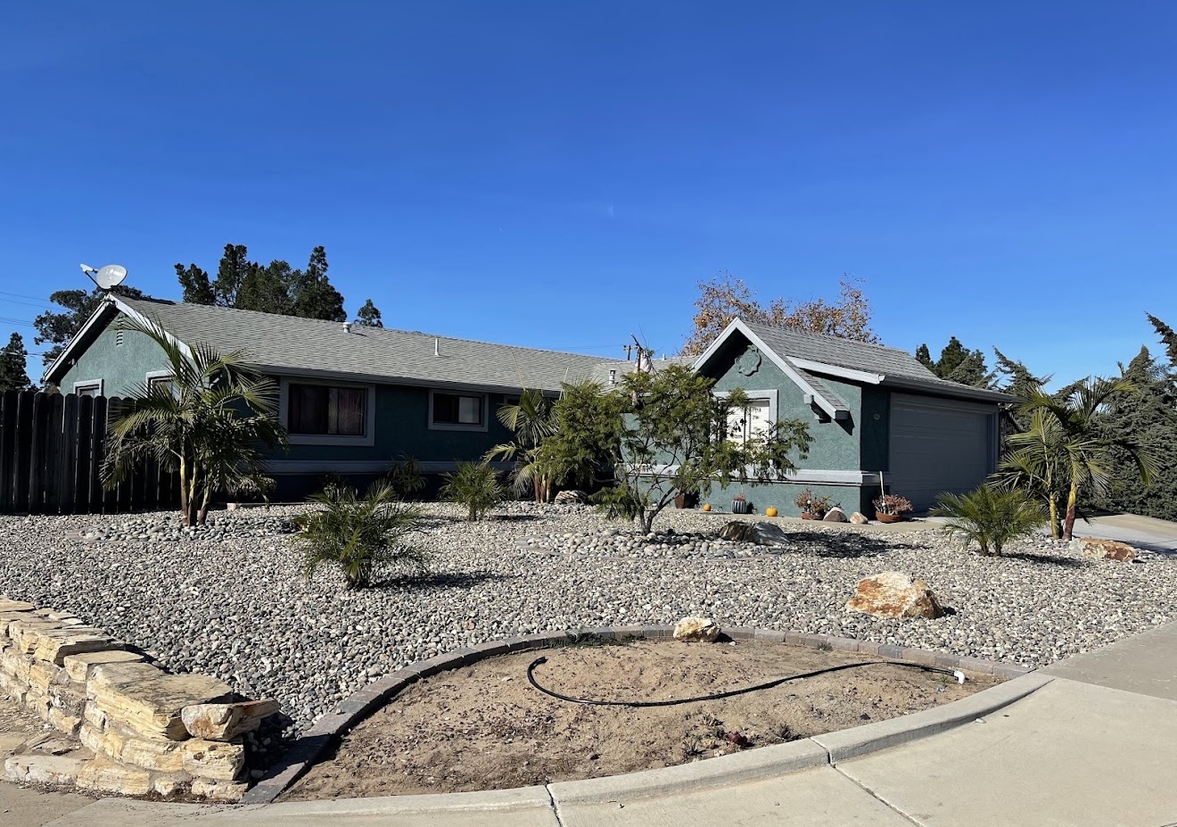 Completed dark green residential exterior painting project by Coastline Painting