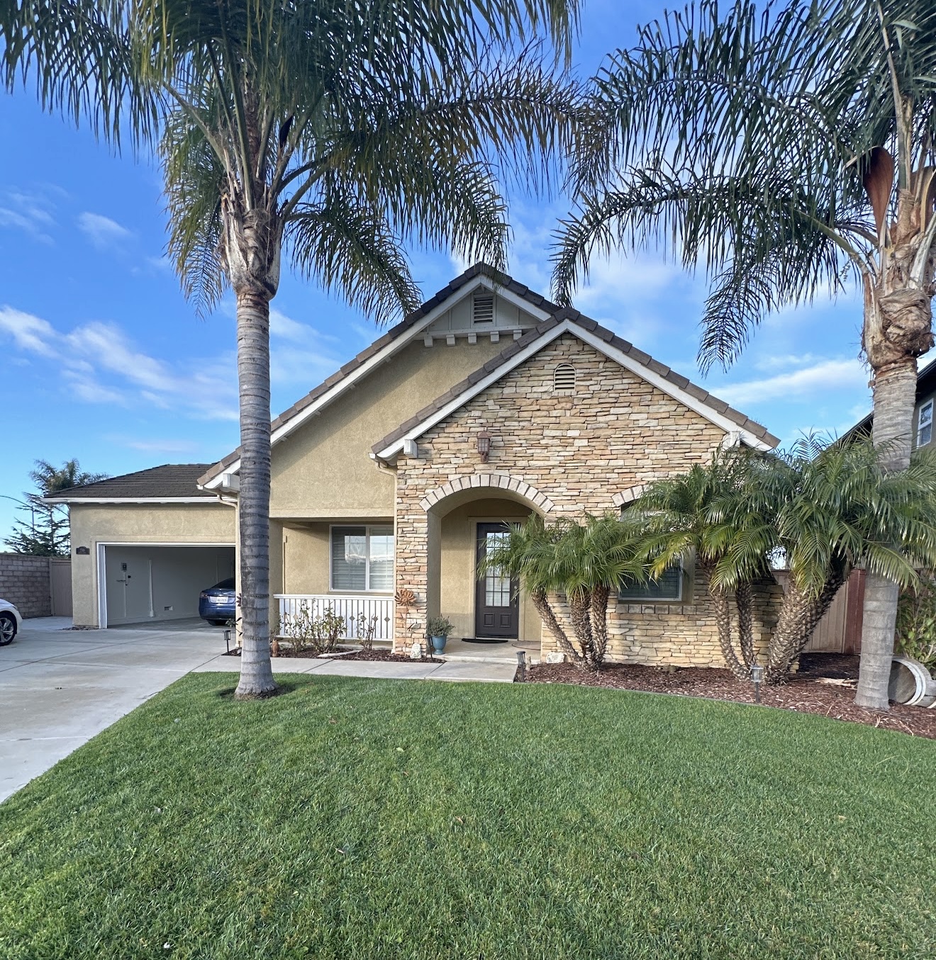 Completed exterior home painting project with stone facade by Coastline Painting
