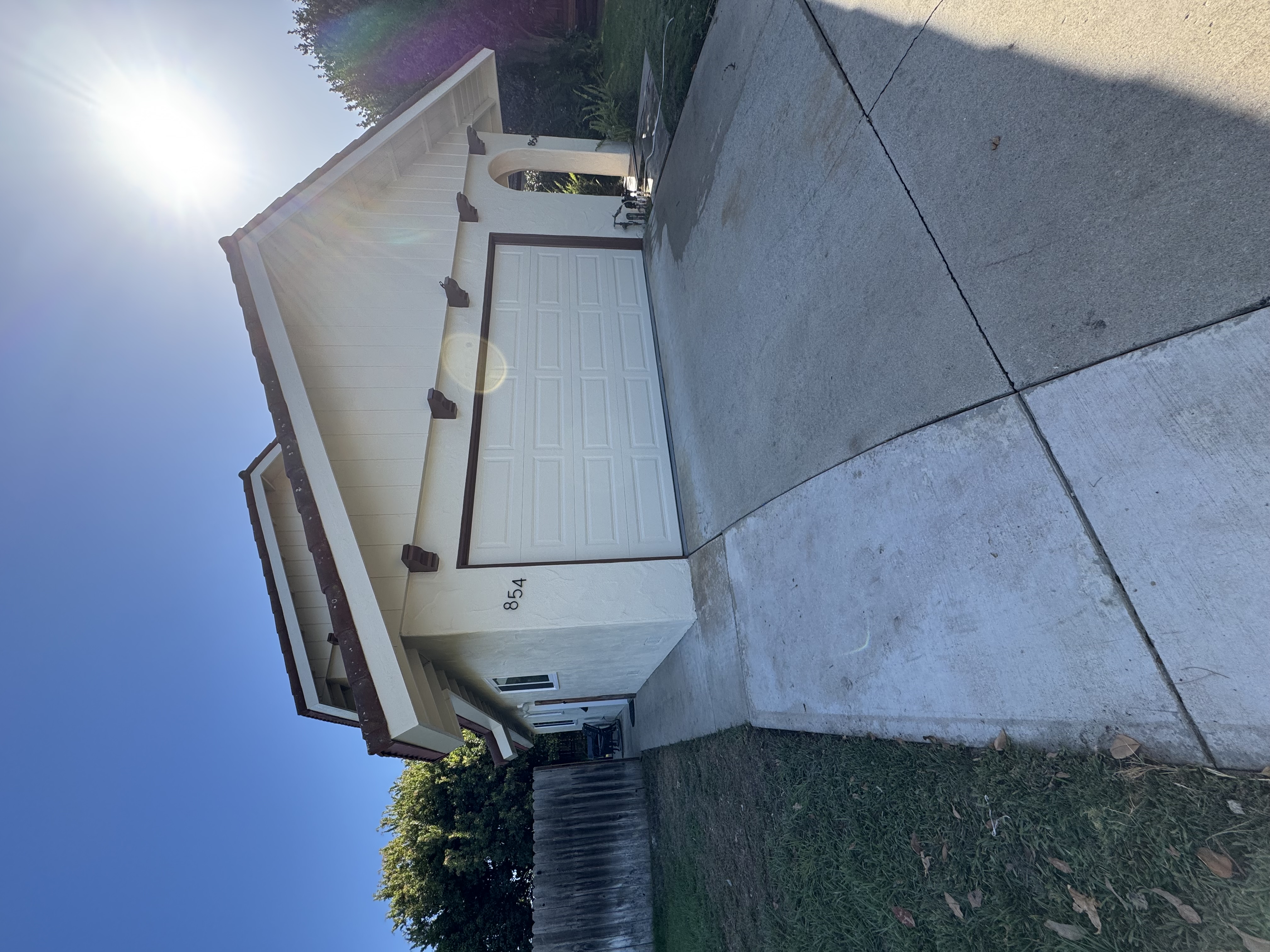 Residential exterior painting project with freshly painted garage and trim by Coastline Painting