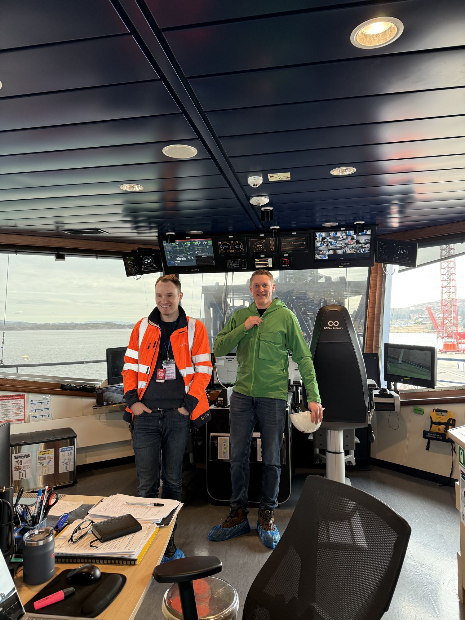 Two Ross Offshore crew members on a vessel's bridge