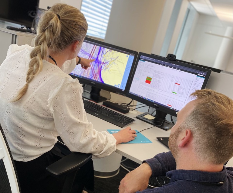 Two engineers reviewing a vessel traffic evaluation on screen