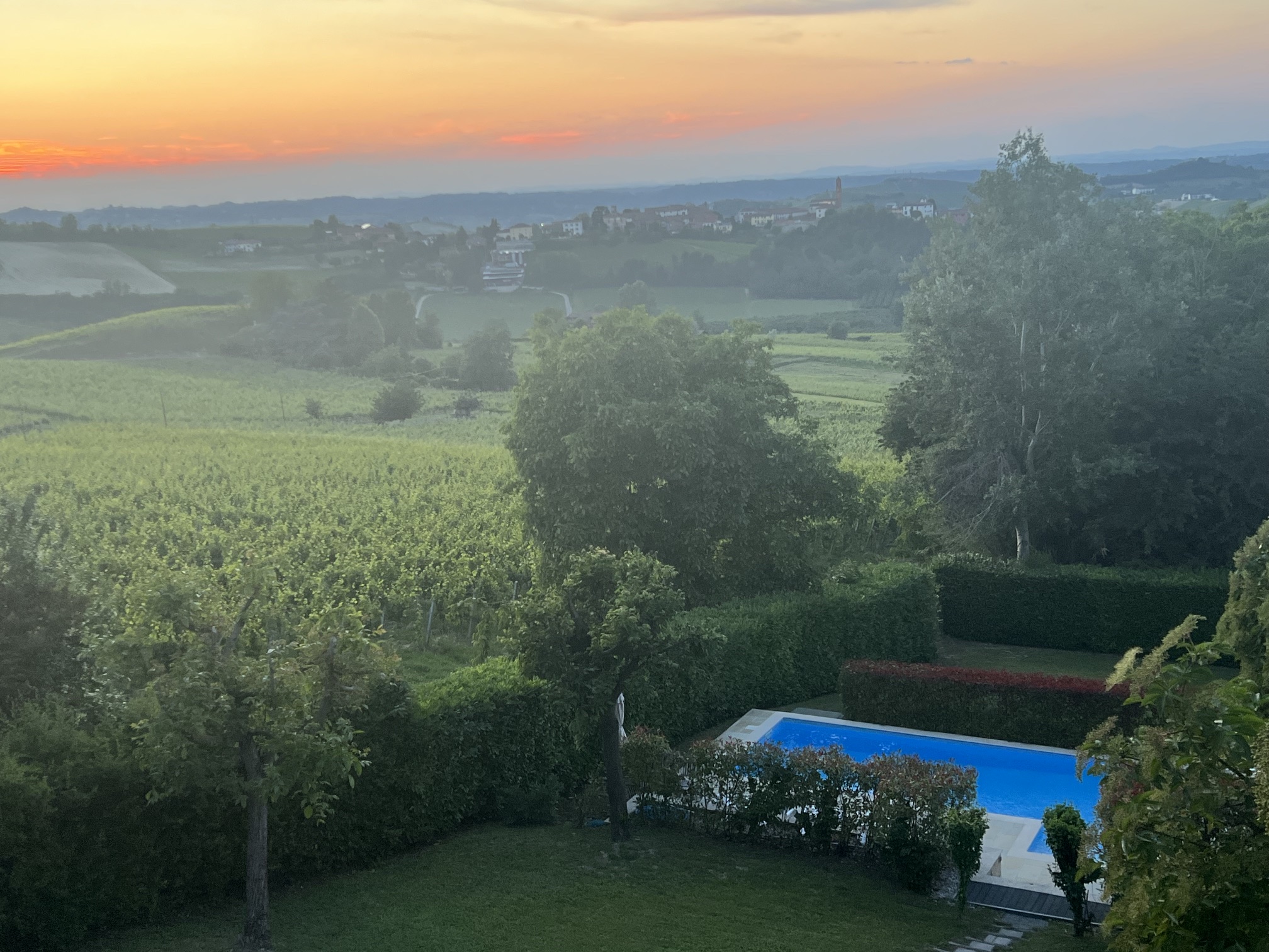 Sunset over the Monferrato vineyards and pool at Cascina Berchi