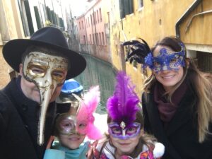 Sean, Angela and their daughters wearing masks during Carnevale in Venice