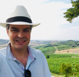 Sean Cochran in the Tuscan vineyard landscape