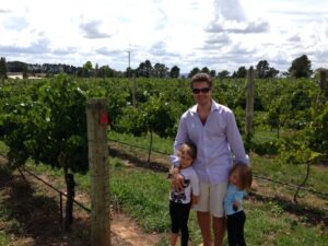 Sean Cochran with his daughters in an Australian vineyard