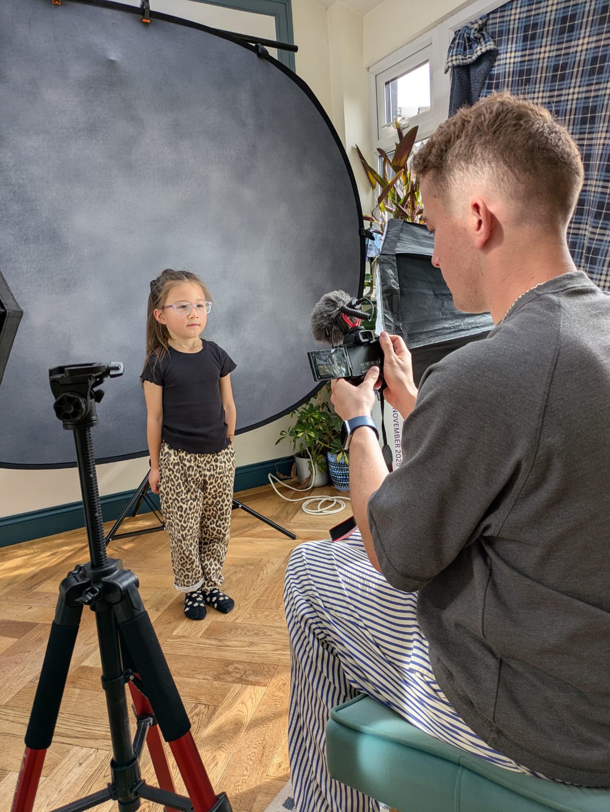 HFTD coach filming a young student on a backdrop during a 1-2-1 session
