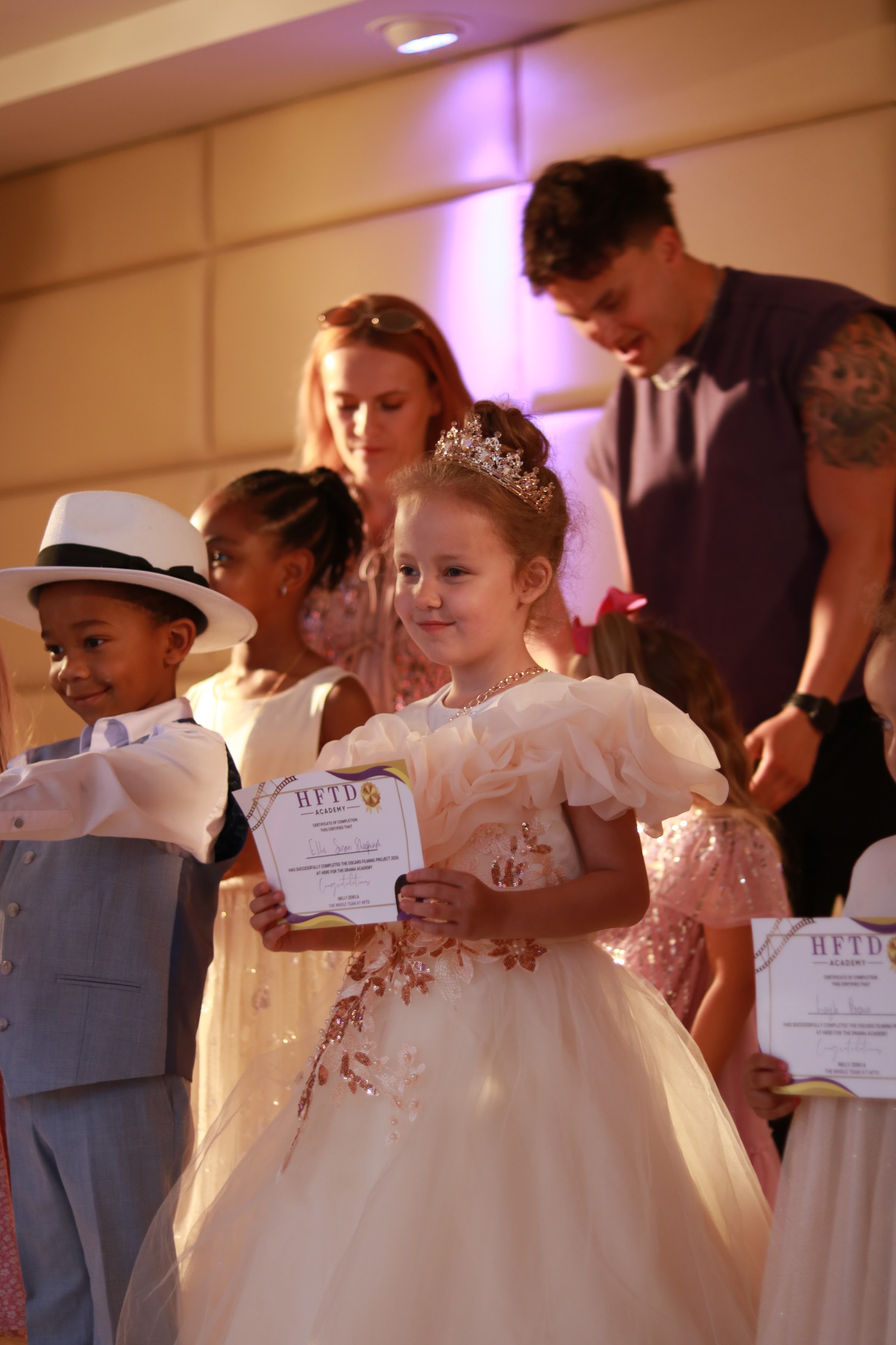 HFTD Minis student collecting her certificate on stage at the HFTD Oscars
