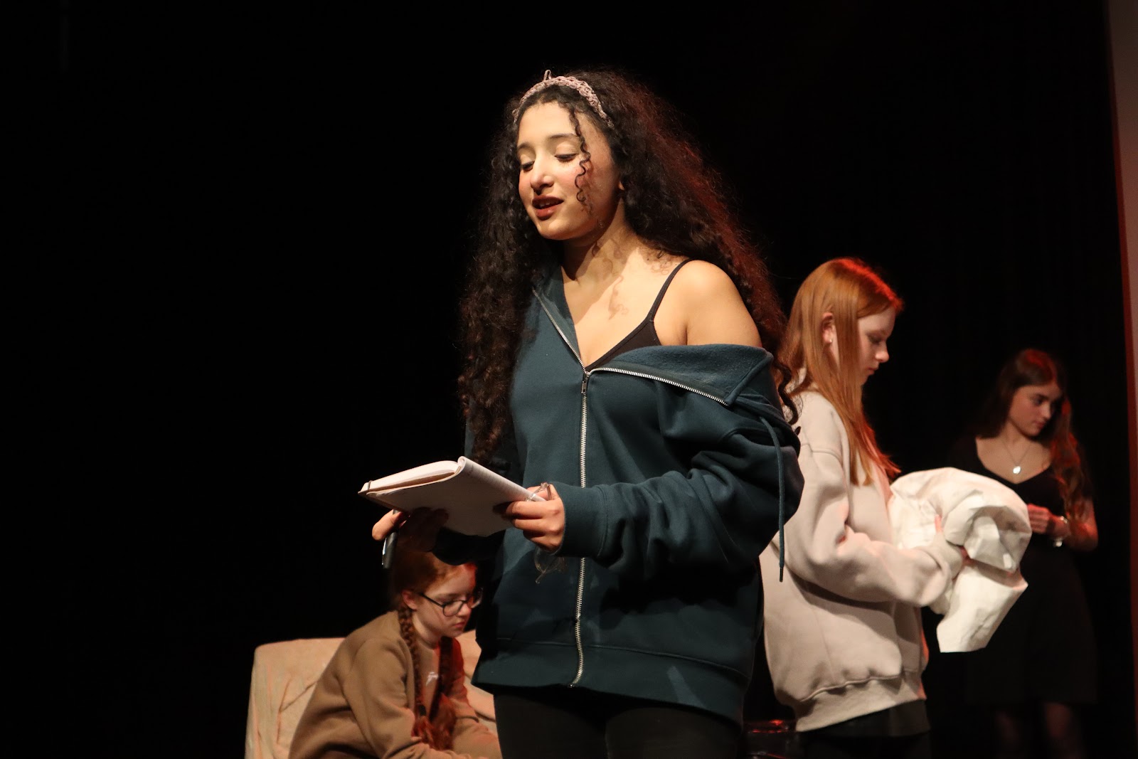 HFTD Pros student working from a script during a theatre dress rehearsal