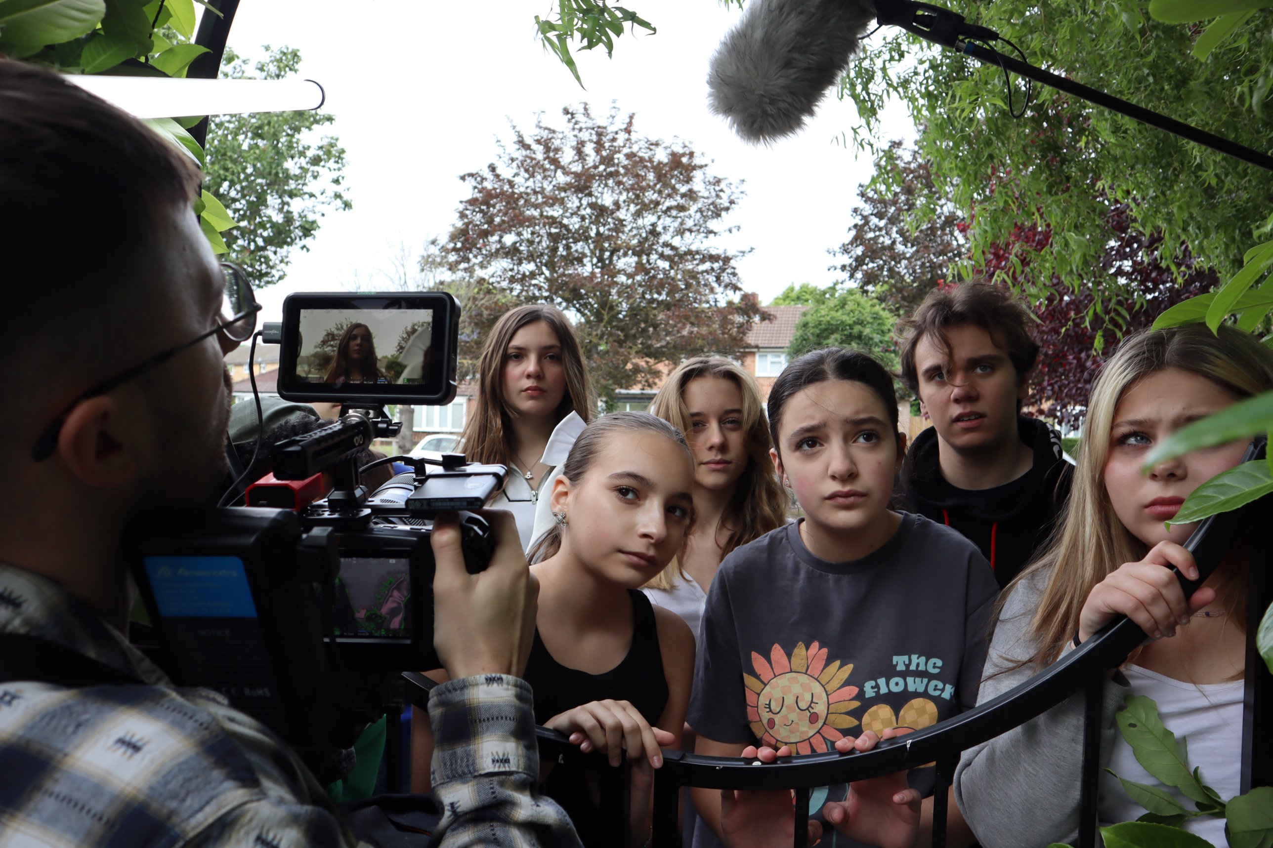 HFTD Pros filming a scene at a garden gate on their Oscars film shoot, camera and boom mic in shot