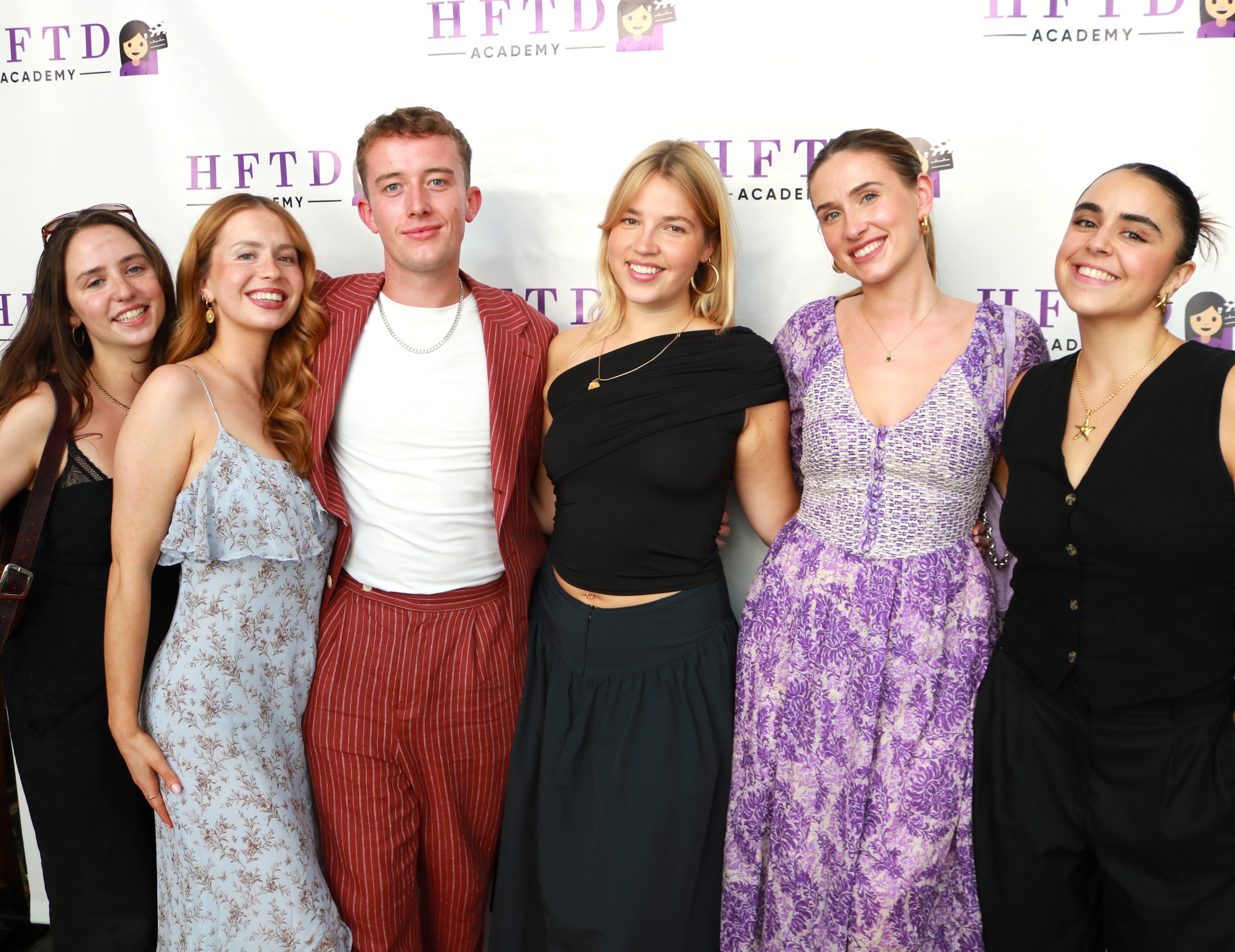 The HFTD team together in front of the HFTD Academy backdrop