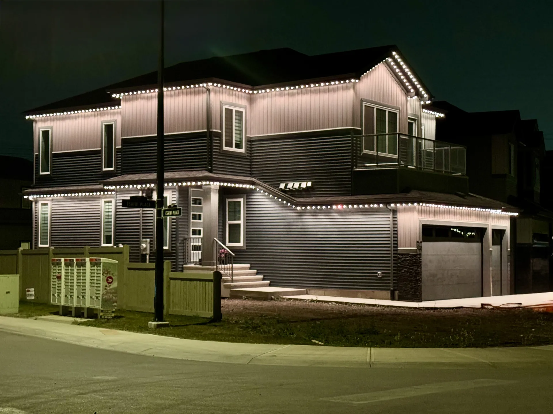 Two-storey home with warm white permanent roofline lights
