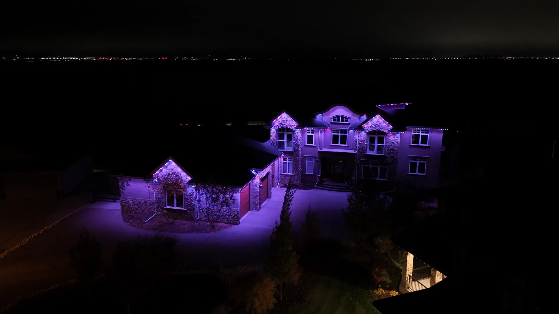 Large home lit in purple permanent LED lighting