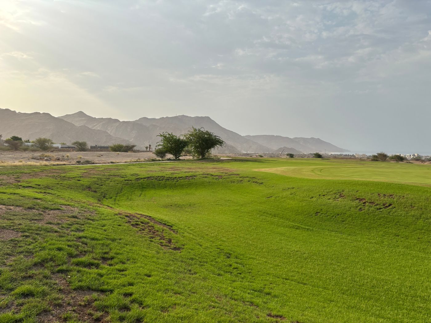 Desert golf course with mountains in the distance