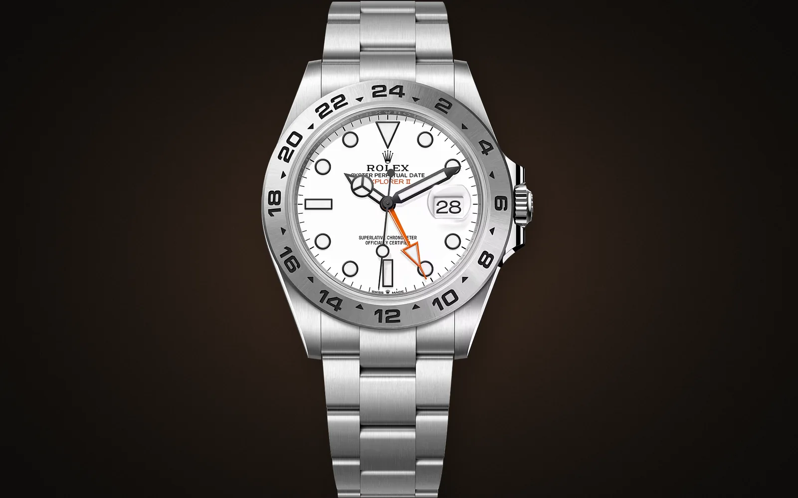 A steel sports watch photographed on a dark background