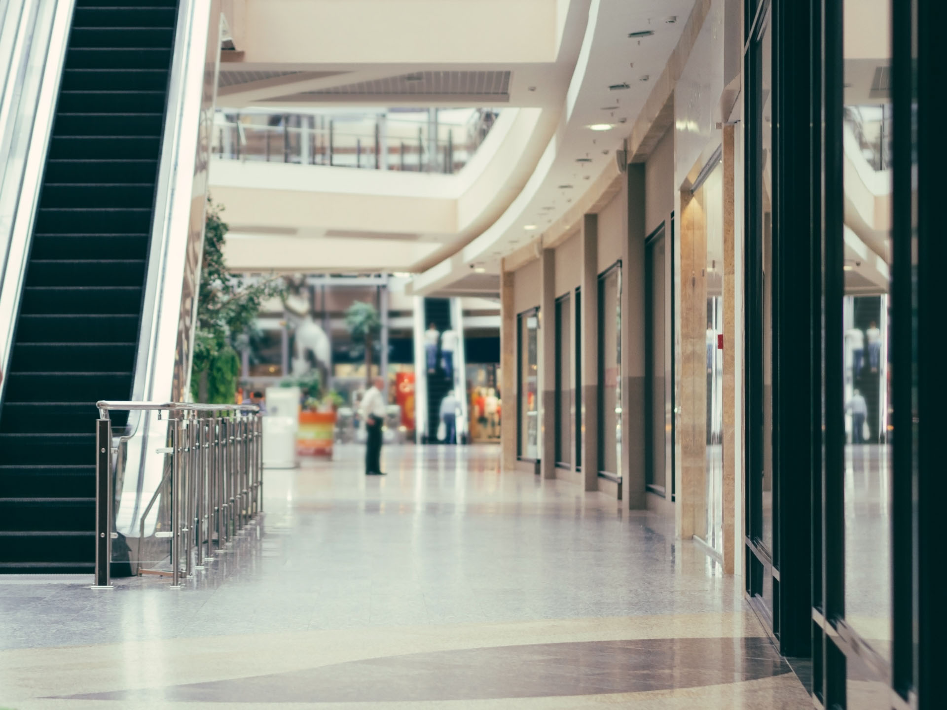 Spotless shopping centre concourse with polished floors and escalator