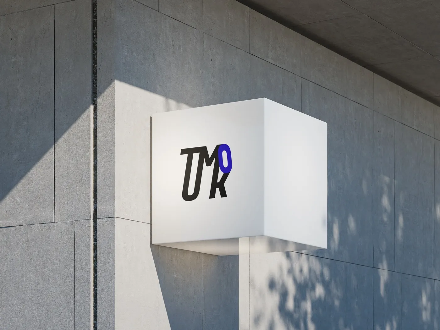 TUMKO.DESIGN identity on an architectural sign — studio mockup