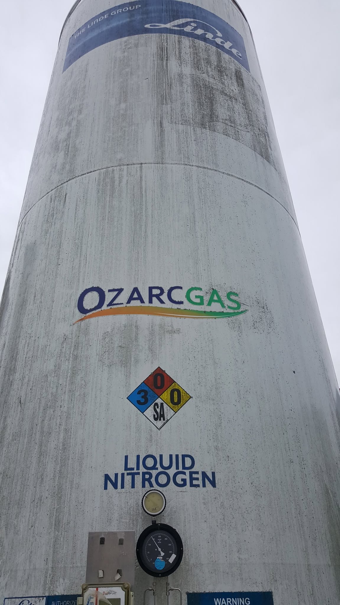 Weathered exterior of an OzarcGas liquid nitrogen tank before cleaning.