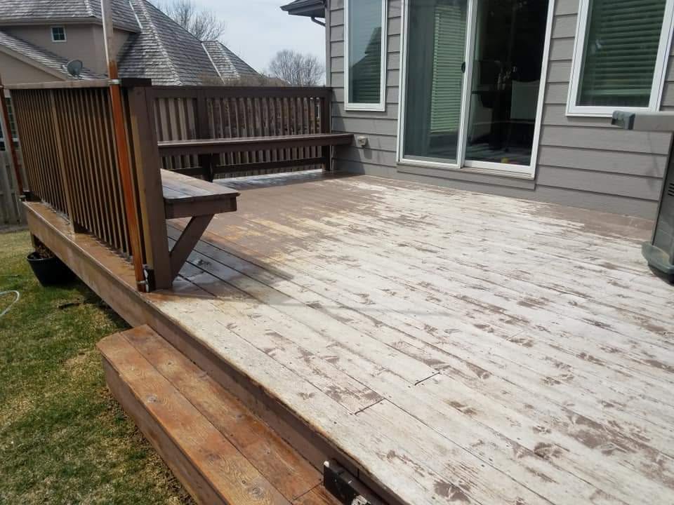Weathered wooden deck before cleaning and restoration.