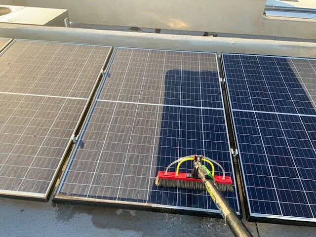 Prowash Missouri technician cleaning rooftop solar panels.