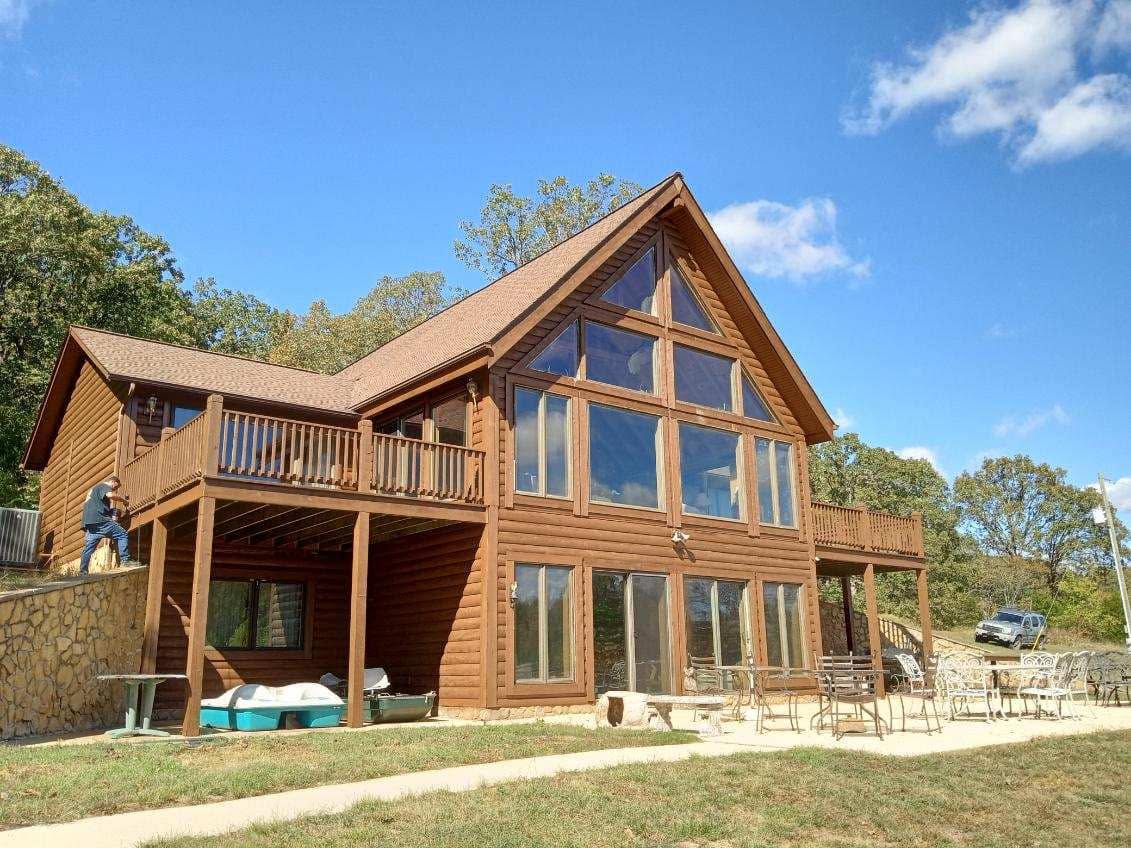Restored log cabin exterior after cleaning and wood restoration