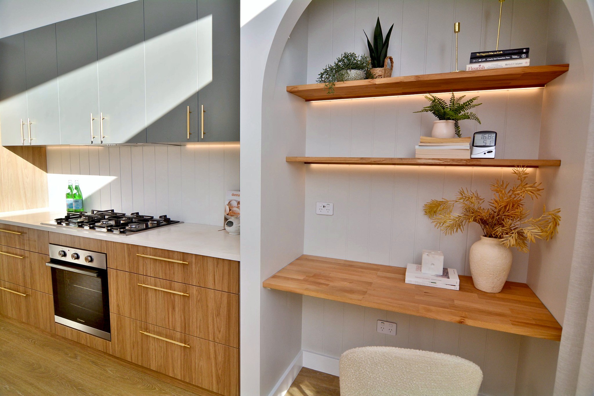 Arched alcove with timber shelves and a built-in desk