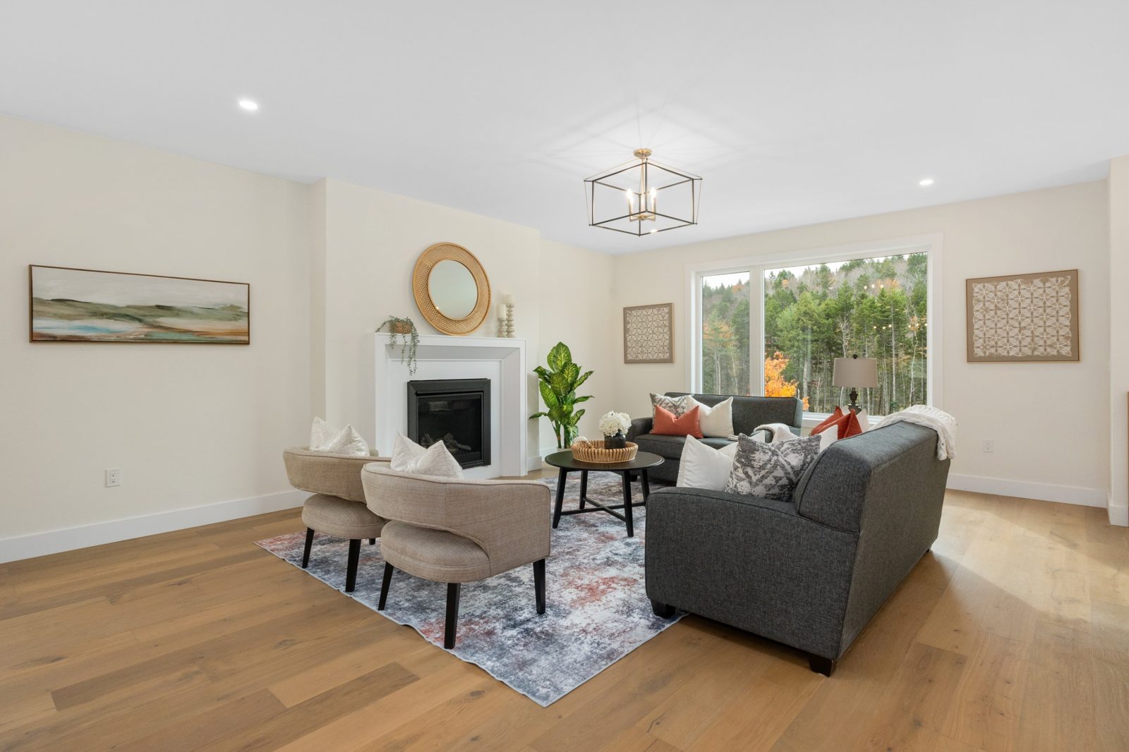 Bright living room with fireplace and forest view in a Shaughnessy Homes new build