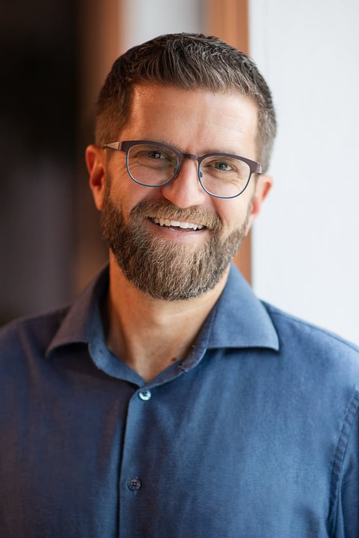 Noah Munro, smiling, in a blue shirt