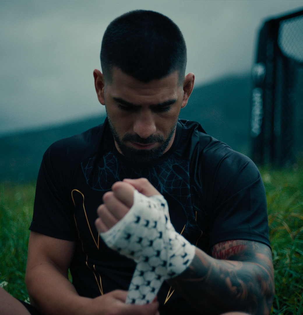 A fighter wrapping his hands in Venum wraps before training