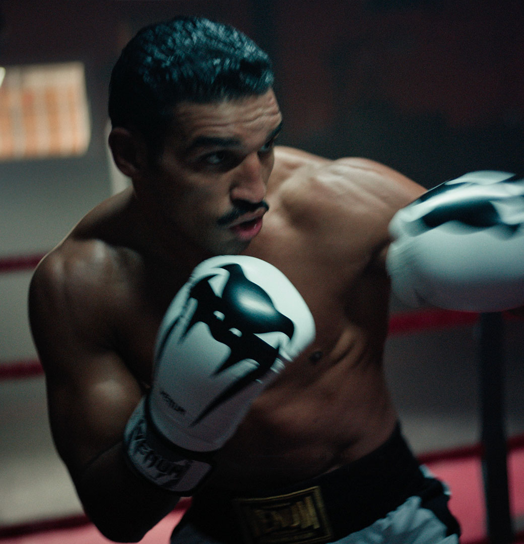 A female boxer on guard in Venum gloves, from the Unstoppable Journey film
