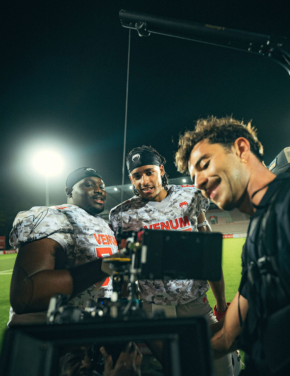 American football players reviewing a take on the monitor, Venum shoot