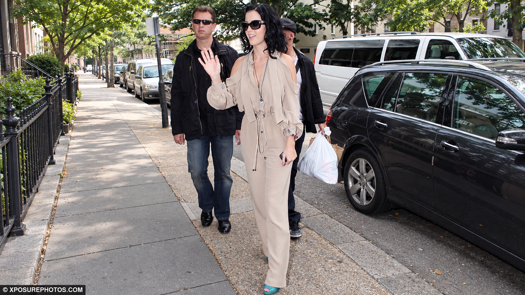 Katy Perry wearing a beige BODYAMR pantsuit on a city sidewalk