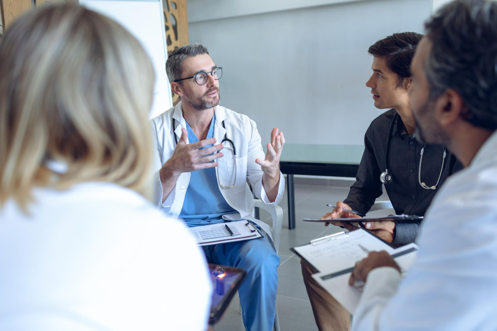 A clinician in conversation with a healthcare professional