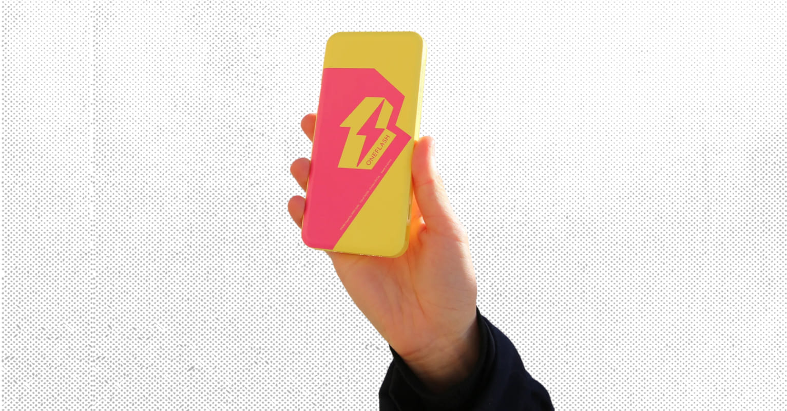 Hand holding a OneFlash power bank on a white background