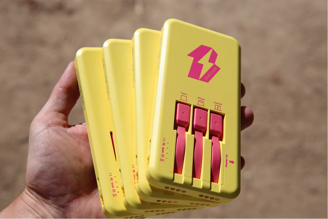 Hand holding several OneFlash power banks