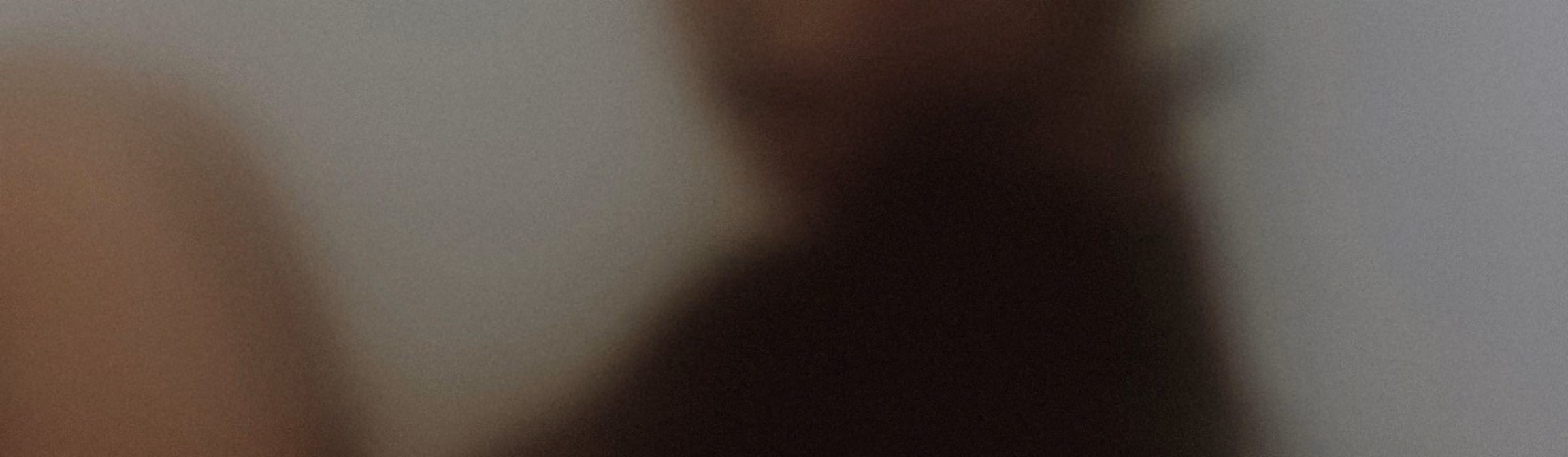 A soft, dark abstract of a figure at rest