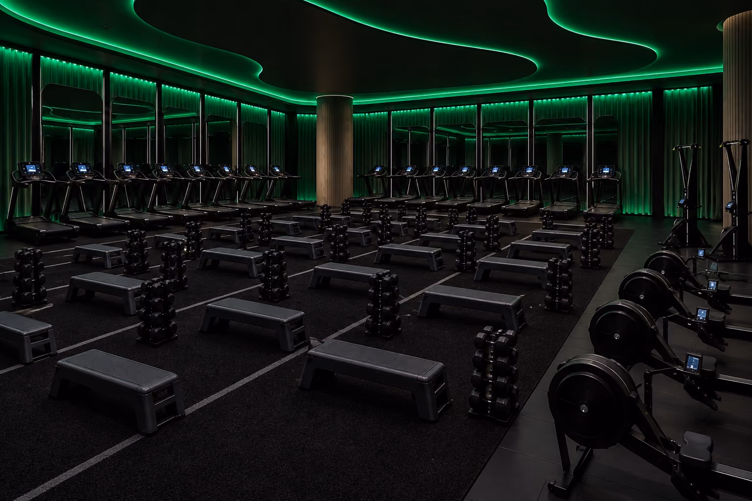 The LF3 HYBRID studio, treadmills and strength stations under green light