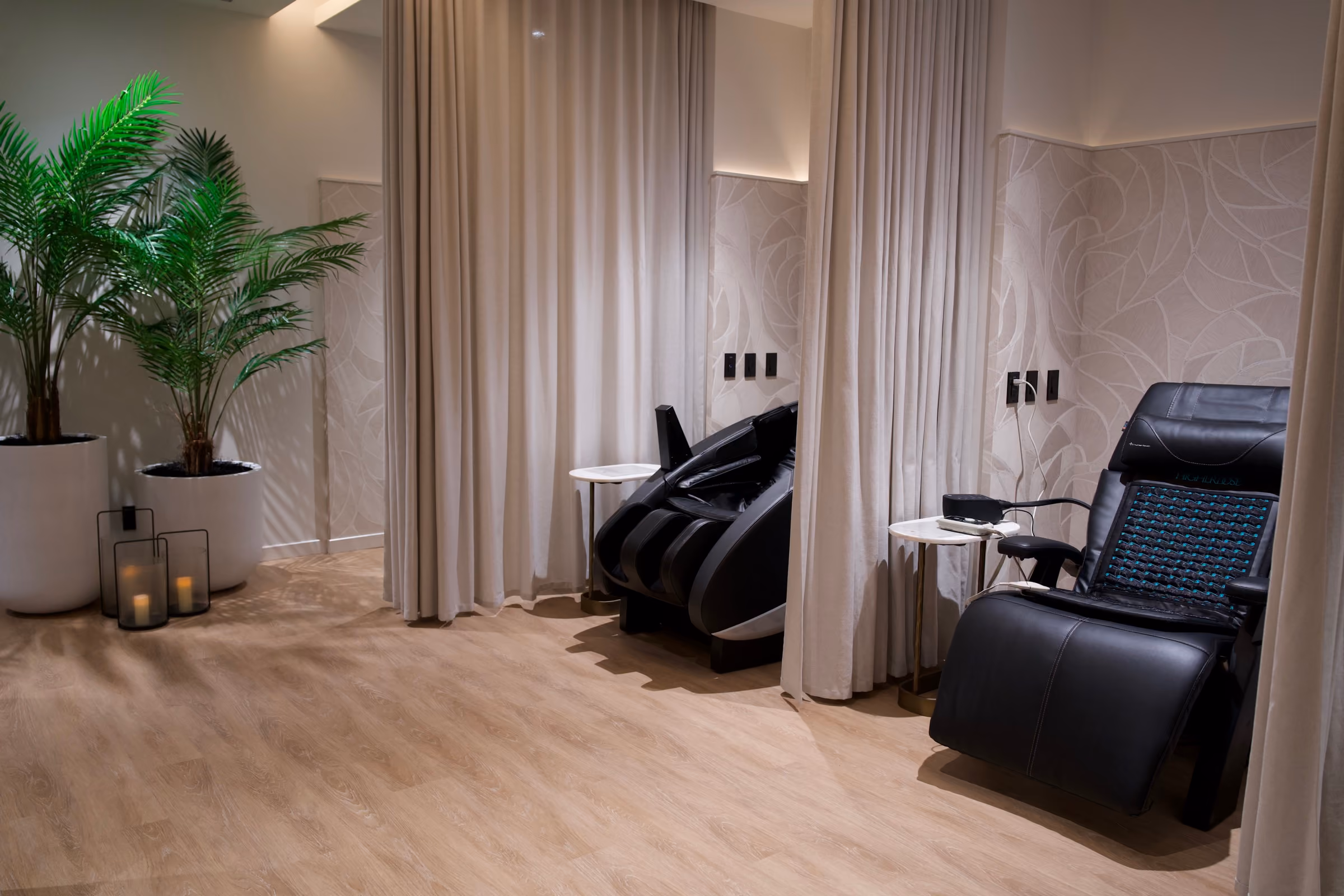 Massage chairs between linen curtains in The Haven
