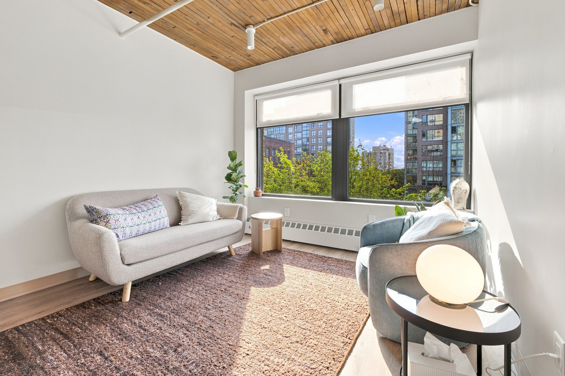 The waiting area at BNFTS, with pale armchairs and a window looking out over Yaletown