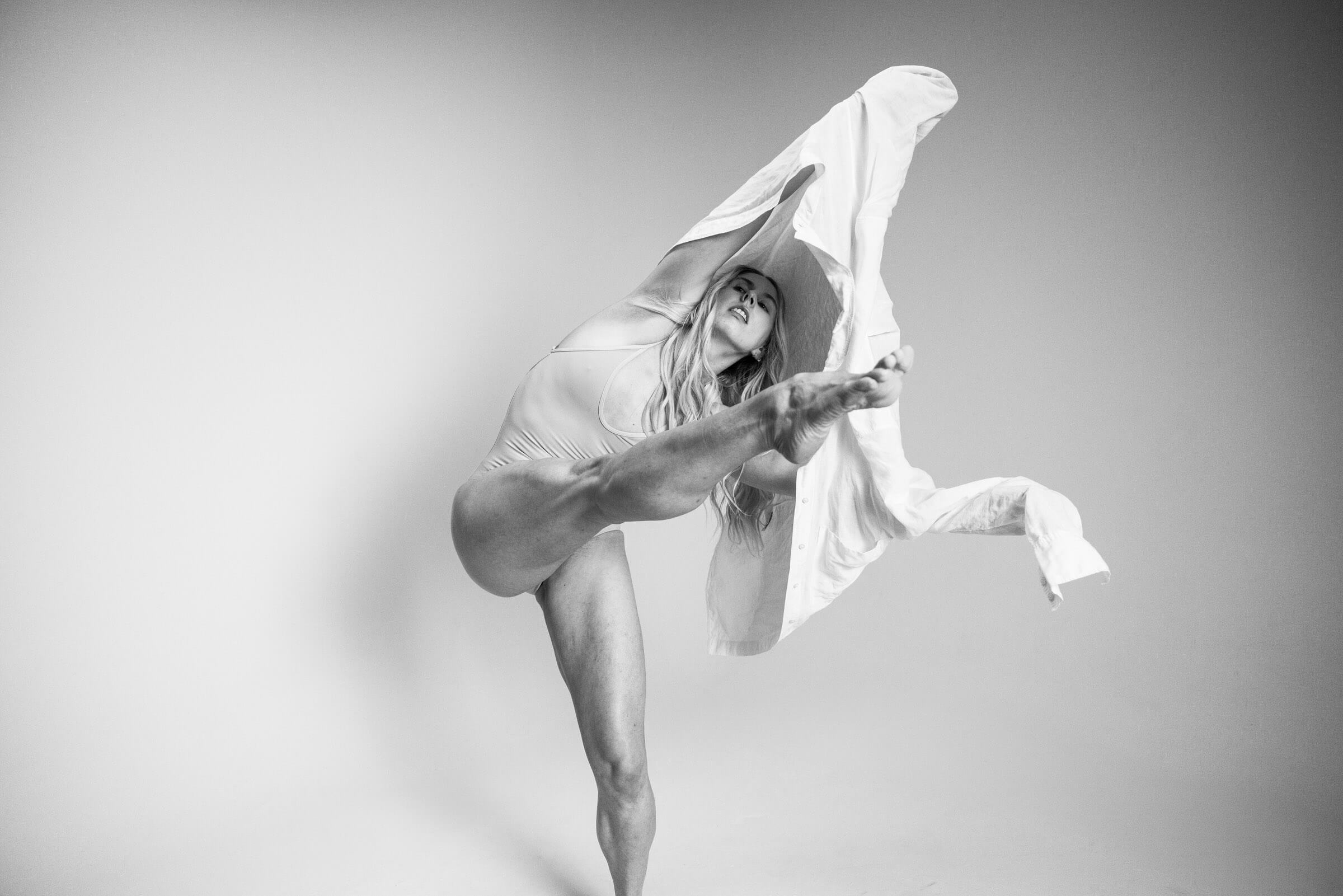 A dancer balanced on one leg in a full extension, from the BNFTS studio shoot